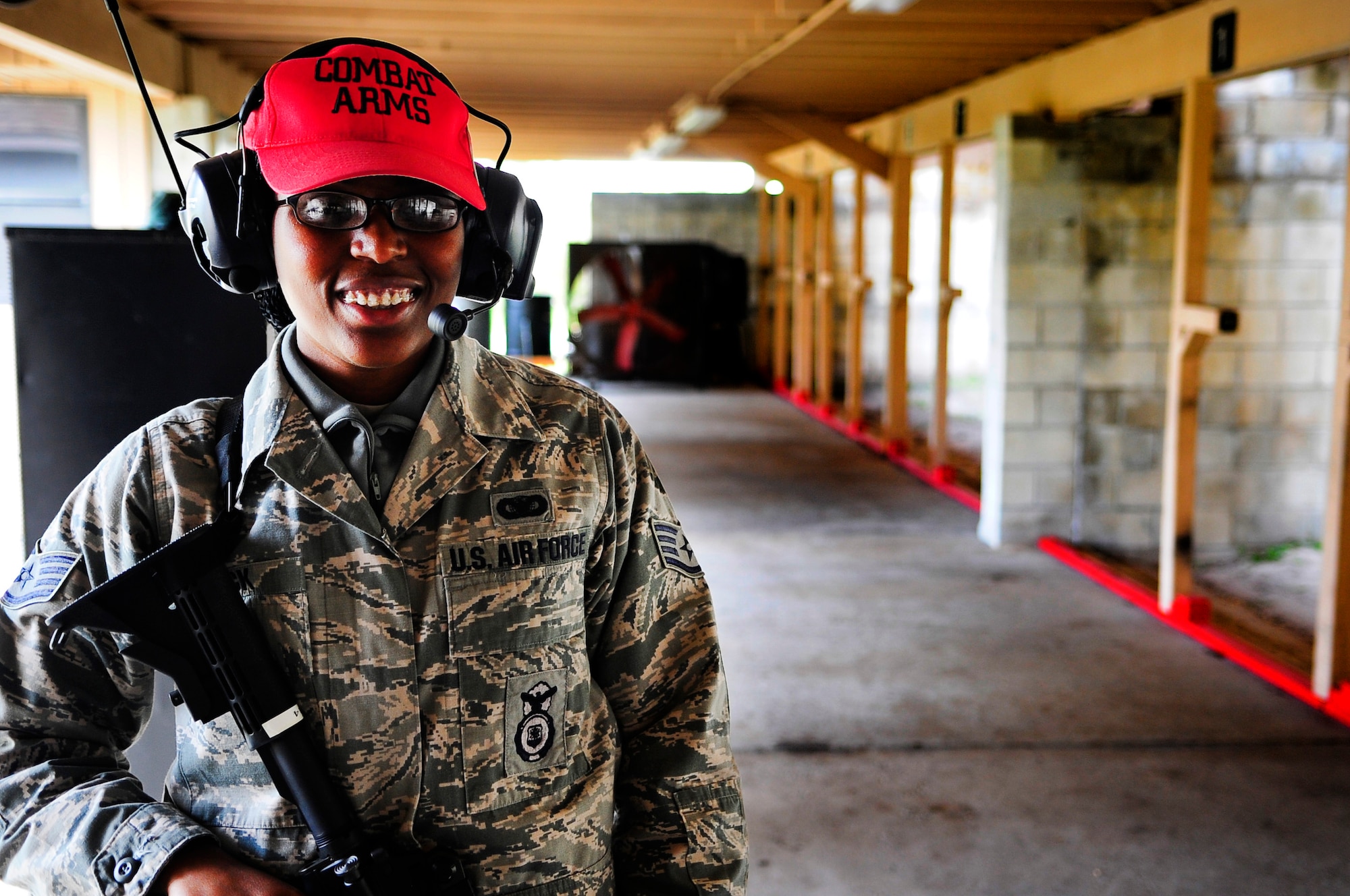 Staff Sgt. Demenica Vick, 6th Security Forces Squadron combat arms training and maintenance instructor, poses for a photo at MacDill Air Force Base, Fla., Nov. 18, 2014. Vick is responsible for ensuring service members who go through the CATM course are qualified and confident in their ability to use their assigned weapon when they are deployed. (U.S. Air Force photo by Senior Airman Jenay Randolph/Released)  