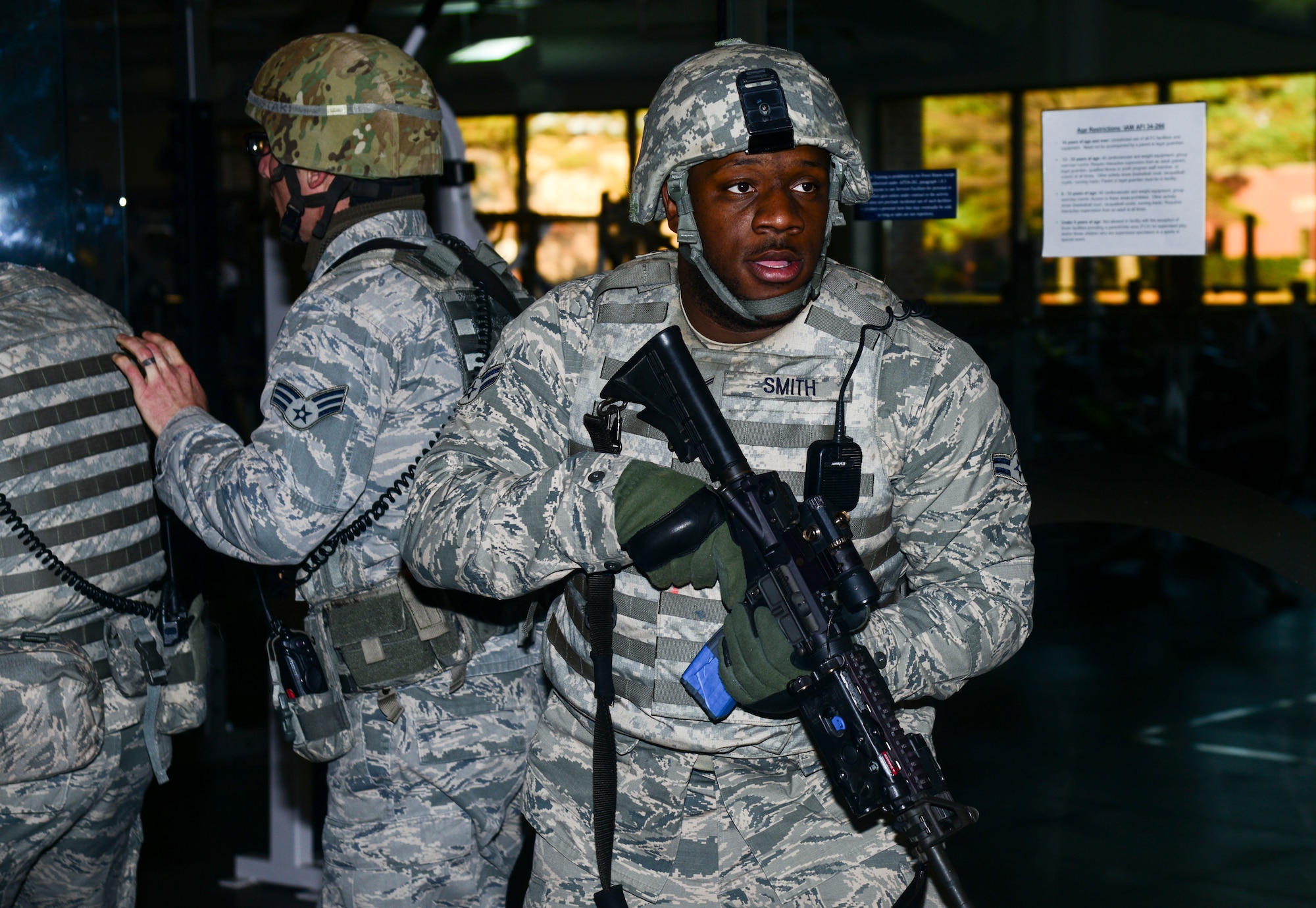U.S. Air Force Airman 1st Class Leandre Smith, 633rd Security Forces Squadron fire team member, responds to an active shooter during an exercise at Langley Air Force Base, Va., Dec. 11, 2014. The exercise tested personnel’s ability to respond, strategize and neutralize a threat. (U.S. Air Force photo by Senior Airman Kayla Newman/Released)