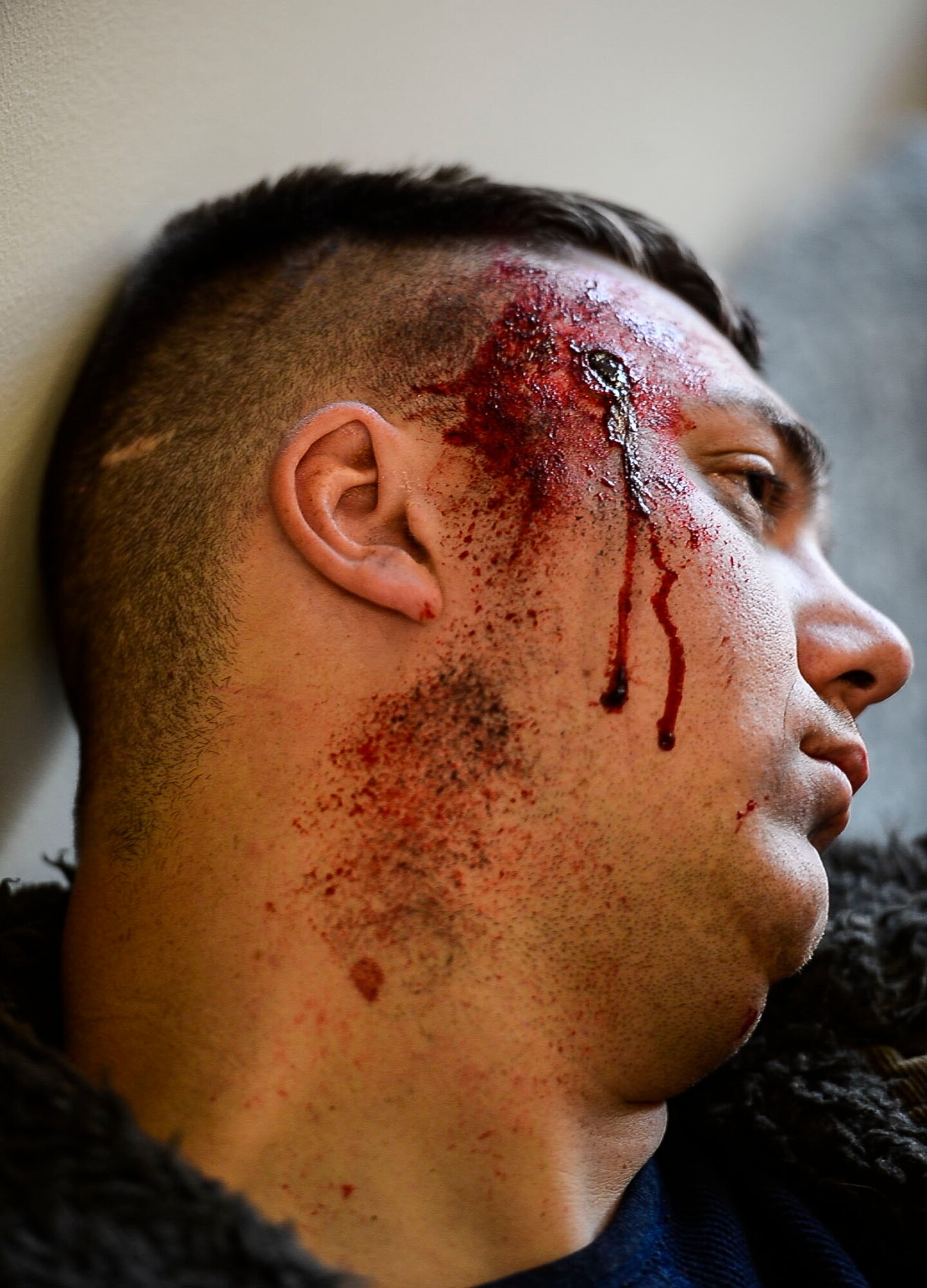U.S. Air Force Staff Sgt. Rock Woods, 633rd Dental Squadron noncommissioned officer in charge of dental logistics, simulates being a casualty during an active shooter exercise at Langley Air Force Base, Va., Dec. 11, 2014. Airmen volunteered to act as victims during the exercise in an effort to provide the most realistic scenario. (U.S. Air Force photo by Senior Airman Kayla Newman/Released)