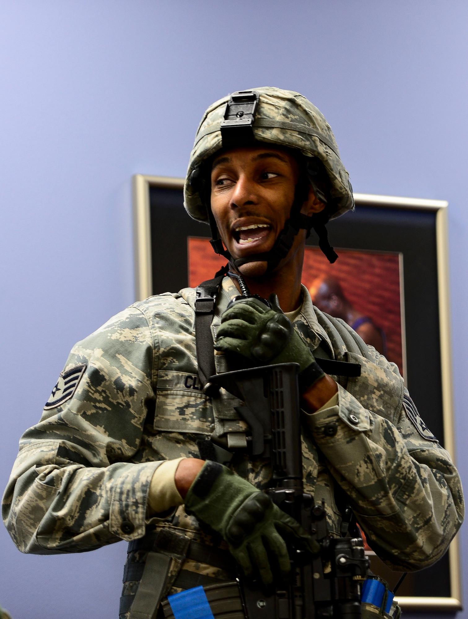 U.S. Air Force Staff Sgt. Richard Clark, 633rd Security Forces base defense operations center controller, radios updates during an active shooter exercise at Langley Air Force Base, Va., Dec. 11, 2014. Clark was the fire team lead during the exercise and directed other members of the team on their roles and responsibilities. (U.S. Air Force photo by Senior Airman Kayla Newman/Released)