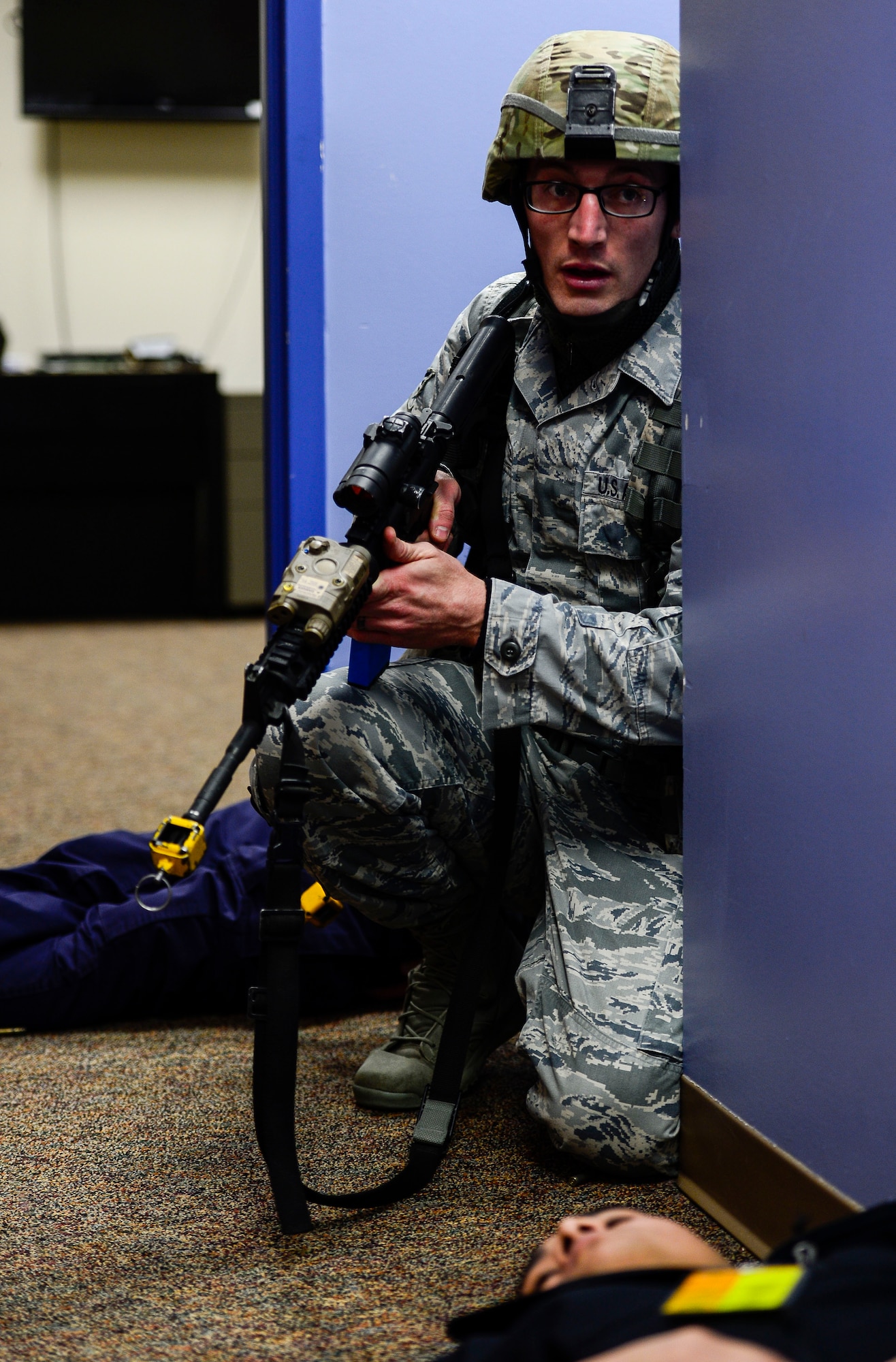 U.S. Air Force Senior Airman John Mustaki, 633rd Security Forces Squadron fire team member, secures an area during an active shooter exercise at Langley Air Force Base, Va., Dec. 11, 2014. Mustaki was responsible for securing the active shooter’s weapon once the threat was neutralized. (U.S. Air Force photo by Senior Airman Kayla Newman/Released)