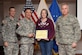 U.S. Army Lt. Col Bartholomew Hennessey, Initial Military Training secretary of the general staff; Col. William Galbraith, 733rd Mission Support Group commander, and U.S. Air Force Col. John J. Allen, Jr., 633rd Air Base Wing commander, far right, recognize Alicia Harrell, 359th Transportation Company, 10th Transportation Battalion, 7th Transportation Brigade (Expeditionary) family readiness group leader, during a Volunteer of the Quarter ceremony at Fort Eustis, Va., Nov. 18, 2014. FRG leaders can volunteer up to 200 hours each month coordinating events and supporting families of deployed U.S. Soldiers. (U.S. Air Force photo by Staff Sgt. Teresa J. Cleveland/Released)