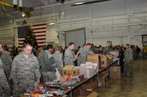 YOUNGSTOWN AIR RESERVE STATION, Ohio – Members of the Air Force Reserve’s 910th Airlift Wing peruse donations of food and gifts provided by the USO of Northern Ohio during the holiday party here Dec. 6, 2014. The holiday party is a long standing annual 910th Airlift Wing tradition. U.S. Air Force photo/Tech. Sgt. Rick Lisum 