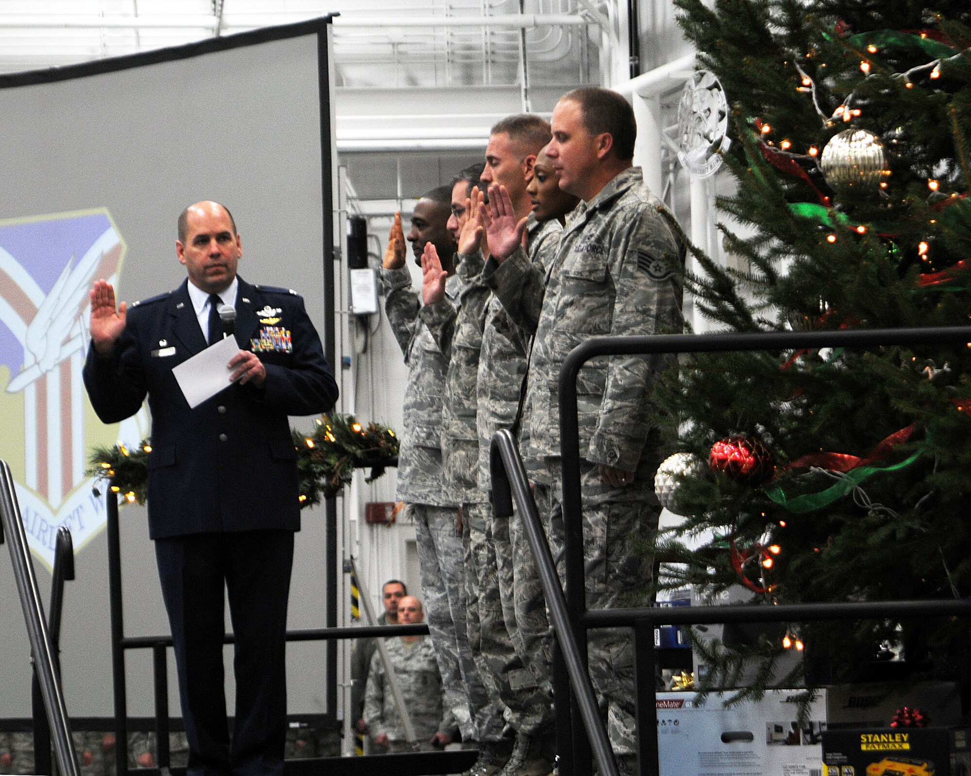 YOUNGSTOWN AIR RESERVE STATION, Ohio – Air Force Reserve Col. James Dignan, 910th Airlift Wing commander, performs a mass reenlistment during a commander’s call in a hangar here, Dec. 6, 2014. The commander’s call was followed by the wing’s holiday party which is a long standing annual 910th Airlift Wing tradition. U.S. Air Force photo/Tech. Sgt. Rick Lisum