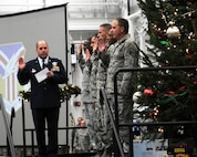 YOUNGSTOWN AIR RESERVE STATION, Ohio – Air Force Reserve Col. James Dignan, 910th Airlift Wing commander, performs a mass reenlistment during a commander’s call in a hangar here, Dec. 6, 2014. The commander’s call was followed by the wing’s holiday party which is a long standing annual 910th Airlift Wing tradition. U.S. Air Force photo/Tech. Sgt. Rick Lisum