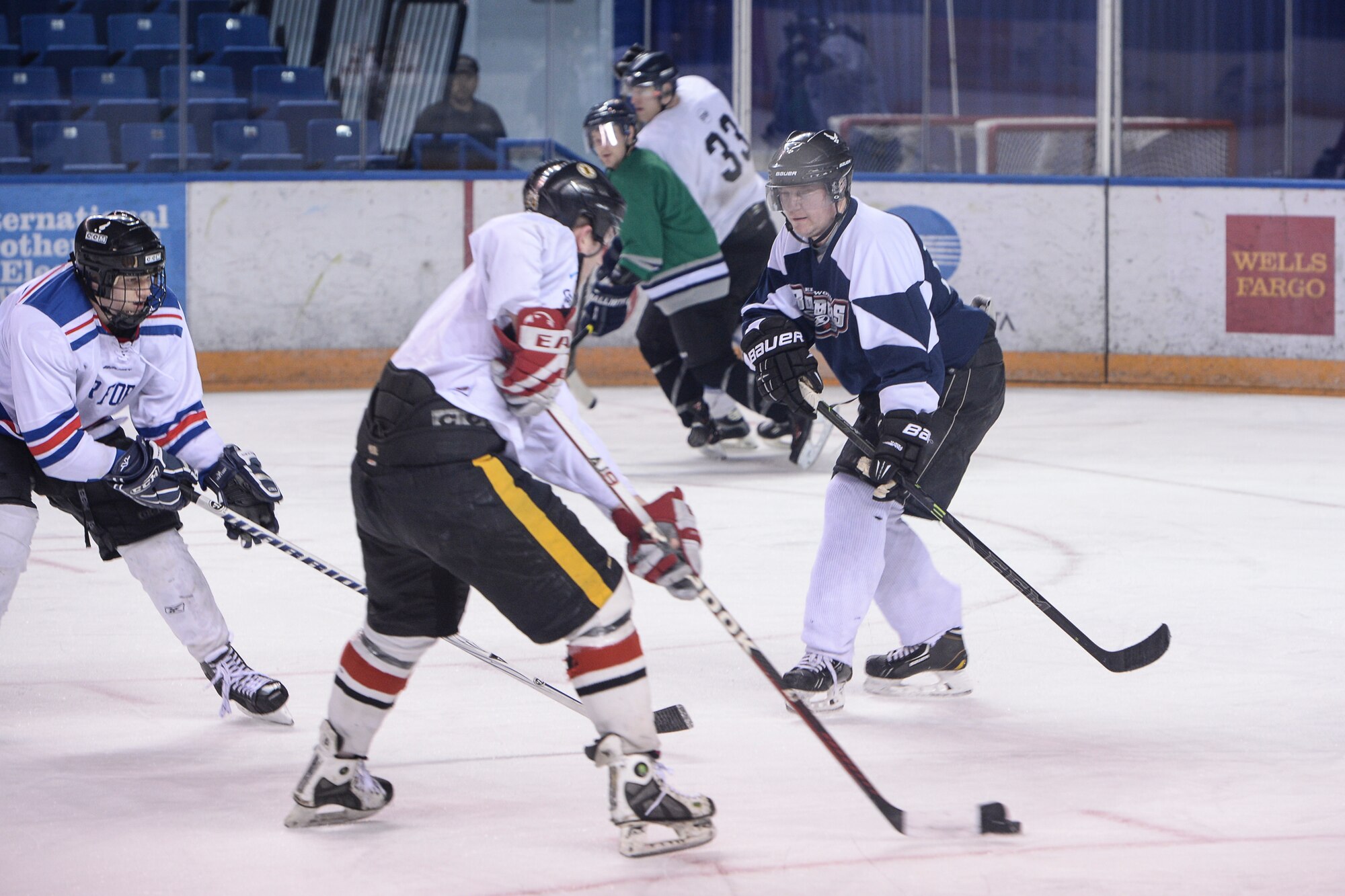 Retired U.S. Air Force Master Sgt. Chris Malenius, Eielson Air Force Base hockey team defenseman, guards his defensive zone Nov. 23, 2014, during practice in Fairbanks, Alaska. Eielson's hockey team was preparing for the upcoming 2014 Commander's Cup came at the Carlson Center against players from Fort Wainwright. (U.S. Air Force photo by Senior Airman Peter Reft/Released)