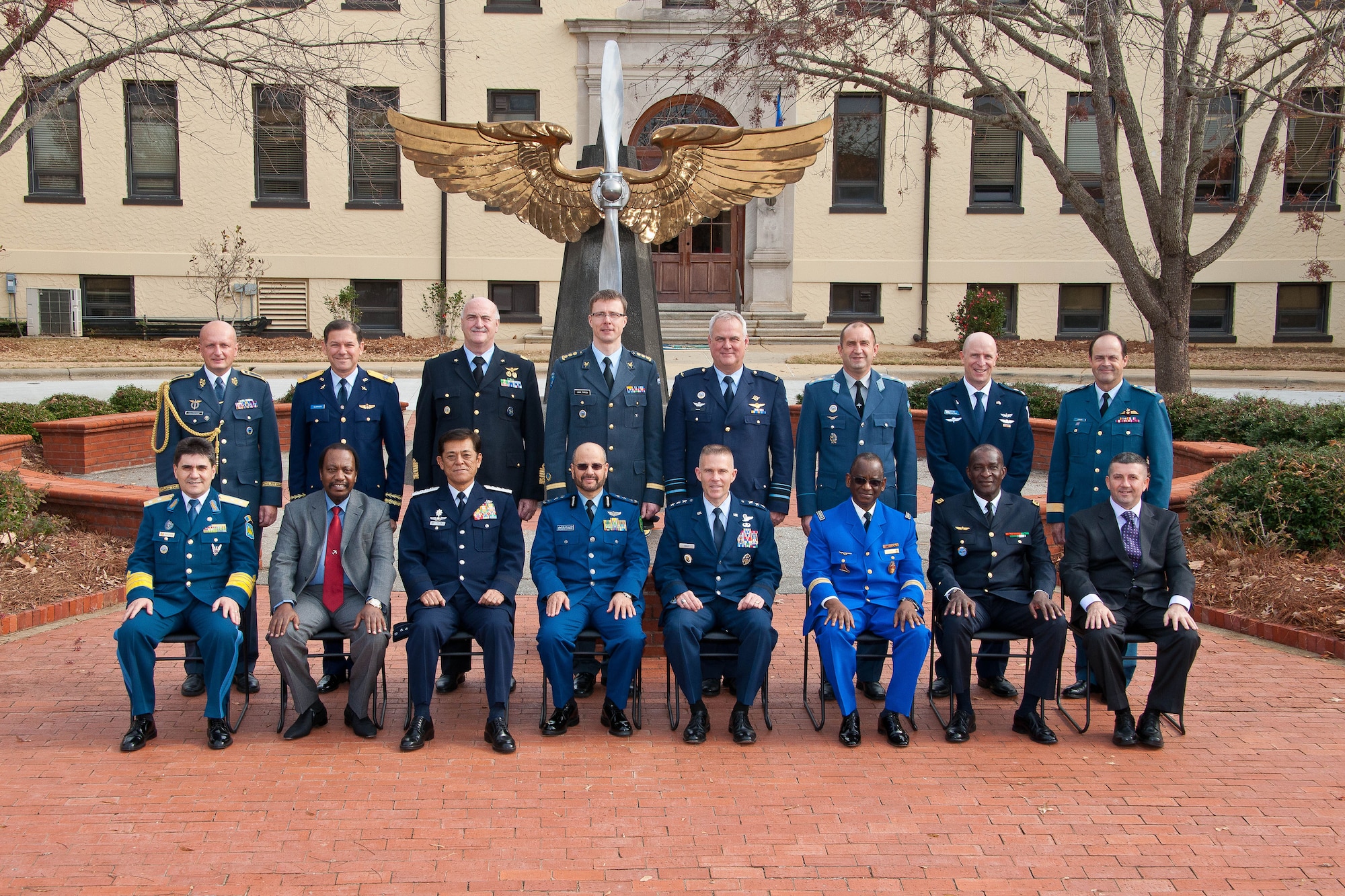 Air University International Honor Roll inductees (or representative) pose in a group photo with Air University Commander Lt. Gen. Seven Kwast (fifth from left) in front of AU headquarters, Dec. 2, 2014. In all, 24 international officers were inducted to the honor roll, which honors the officers for acceding to the highest positions in their respective country’s government or military. (USAF Photo by Donna L. Burnett/Cleared)