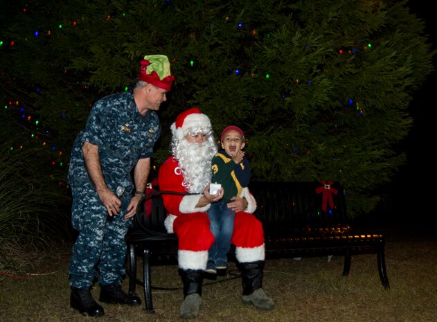 U.S. Navy Capt. Timothy Sparks, Joint Base Charleston deputy commander,   along with Santa Claus and a young volunteer light the Christmas tree during the annual Christmas tree lighting ceremony Dec. 4, 2014, on JB Charleston - Weapons Station, S.C. The tree lighting is an annual tradition held at both the Air Base and Weapons Station to kick off the holiday season. (U.S. Air Force photo/Senior Airman Melissa Goslin)