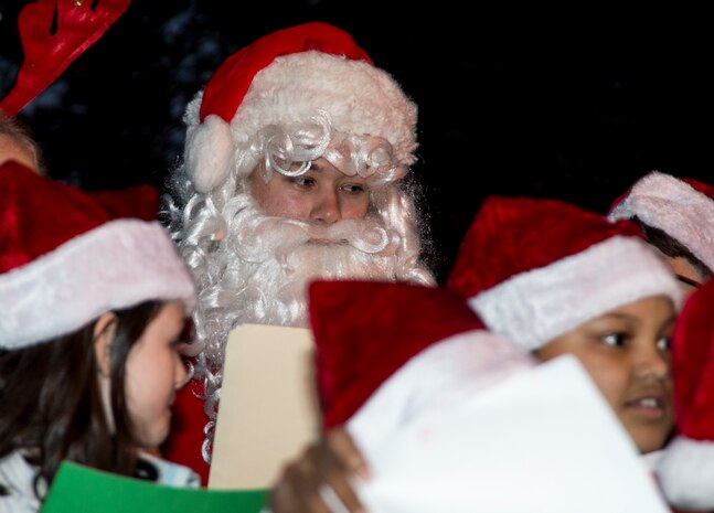 Santa sings Christmas carols with children from the Joint Base Charleston Youth Center during the annual Christmas tree lighting ceremony Dec. 4, 2014, on JB Charleston - Weapons Station, S.C. The tree lighting is an annual tradition held at both the Air Base and Weapons Station to kick off the holiday season. (U.S. Air Force photo/Senior Airman Melissa Goslin)