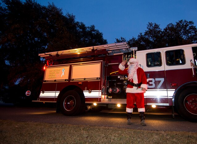 Santa makes a surprise entrance on a fire truck during the annual Christmas tree lighting ceremony Dec. 4, 2014, on Joint Base Charleston - Weapons Station, S.C. The tree lighting is an annual tradition held at both the Air Base and Weapons Station to kick off the holiday season. (U.S. Air Force photo/Senior Airman Melissa Goslin)