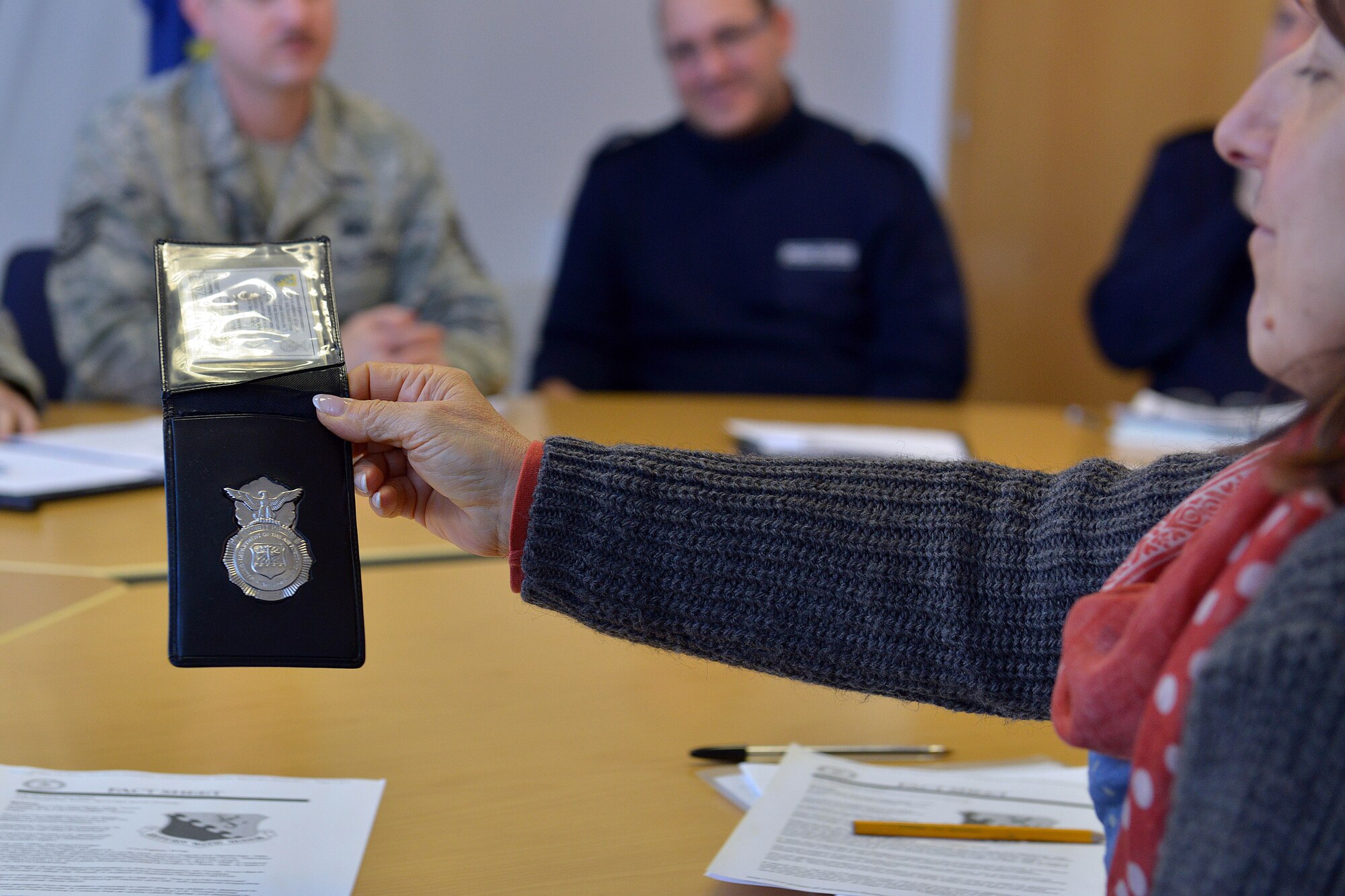 An Aviano Polizia Locale officer passes around an U.S. Air Force security forces badge, Dec. 10, 2014, at the Commune in Aviano, Italy. The security forces shield represents a symbol of authority and gives responsibility to each member who wears it. The local police invited the 31 SFS’s members to come to their headquarters to discuss Aviano’s mission and how the two forces could work closer together. (U.S. Air Force photo/Airman 1st Class Ryan Conroy)