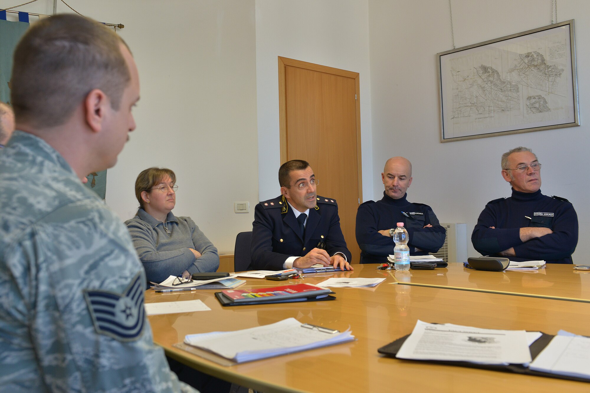 Two 31st Security forces Squadron members and Aviano Polizia Locale officers discuss mission responsibilities, Dec. 10, 2014, at the Commune in Aviano, Italy. Security forces members met with local police officers to explain Aviano Air Base’s mission, law enforcement in an overseas community, and authority on and off base. (U.S. Air Force photo/Airman 1st Class Ryan Conroy) 