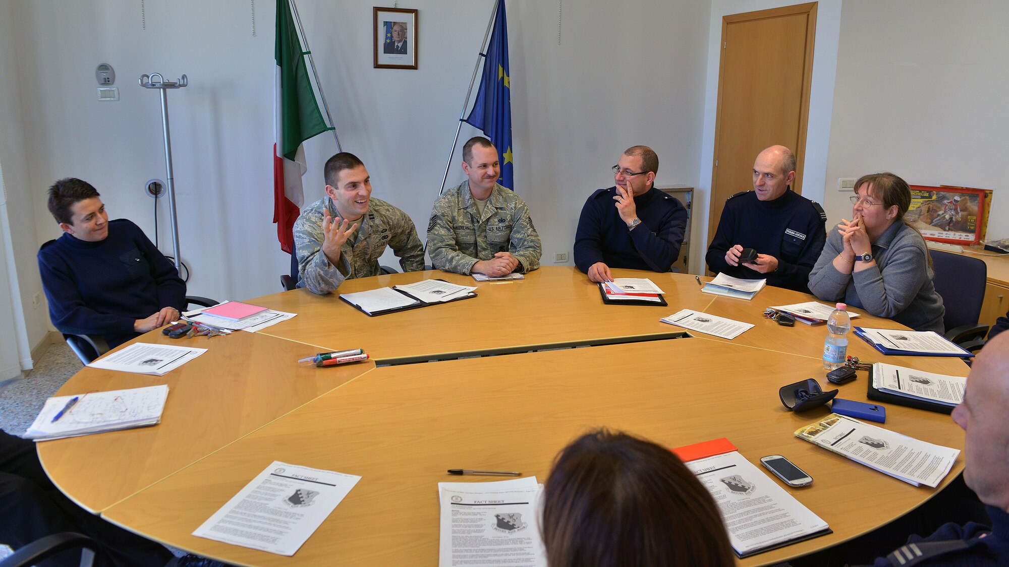 Capt. Benjamin Joelson and Tech. Sgt. Alexander Hickernell, 31st Security Forces Squadron assistant operations officer and assistant flight chief, speak to Aviano Polizia Locale officers, Dec. 10, 2014, at the Commune in Aviano, Italy. The local police invited the 31 SFS’s members to come to their headquarters to discuss Aviano’s mission and how the two forces could work closer together. (U.S. Air Force photo/Airman 1st Class Ryan Conroy)   