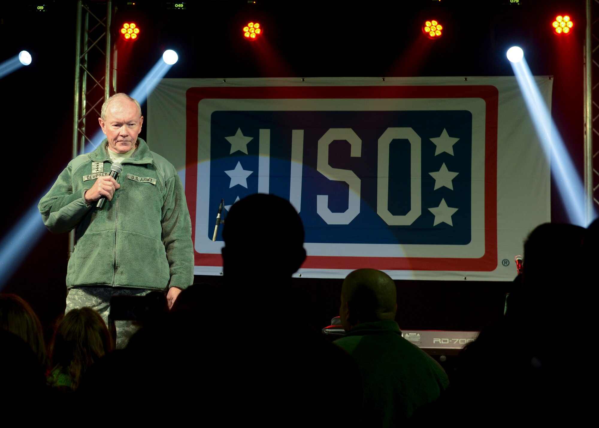 U.S. Army Gen. Martin E. Dempsey, Chairman of the Joint Chiefs of Staff, speaks during the USO holiday tour Dec. 10, 2014, on RAF Mildenhall, England. The general was joined by singers, actors and sports icons on his fourth and final USO tour to visit service members during the holiday season. (U.S. Air Force photo by Senior Airman Victoria H. Taylor/Released)