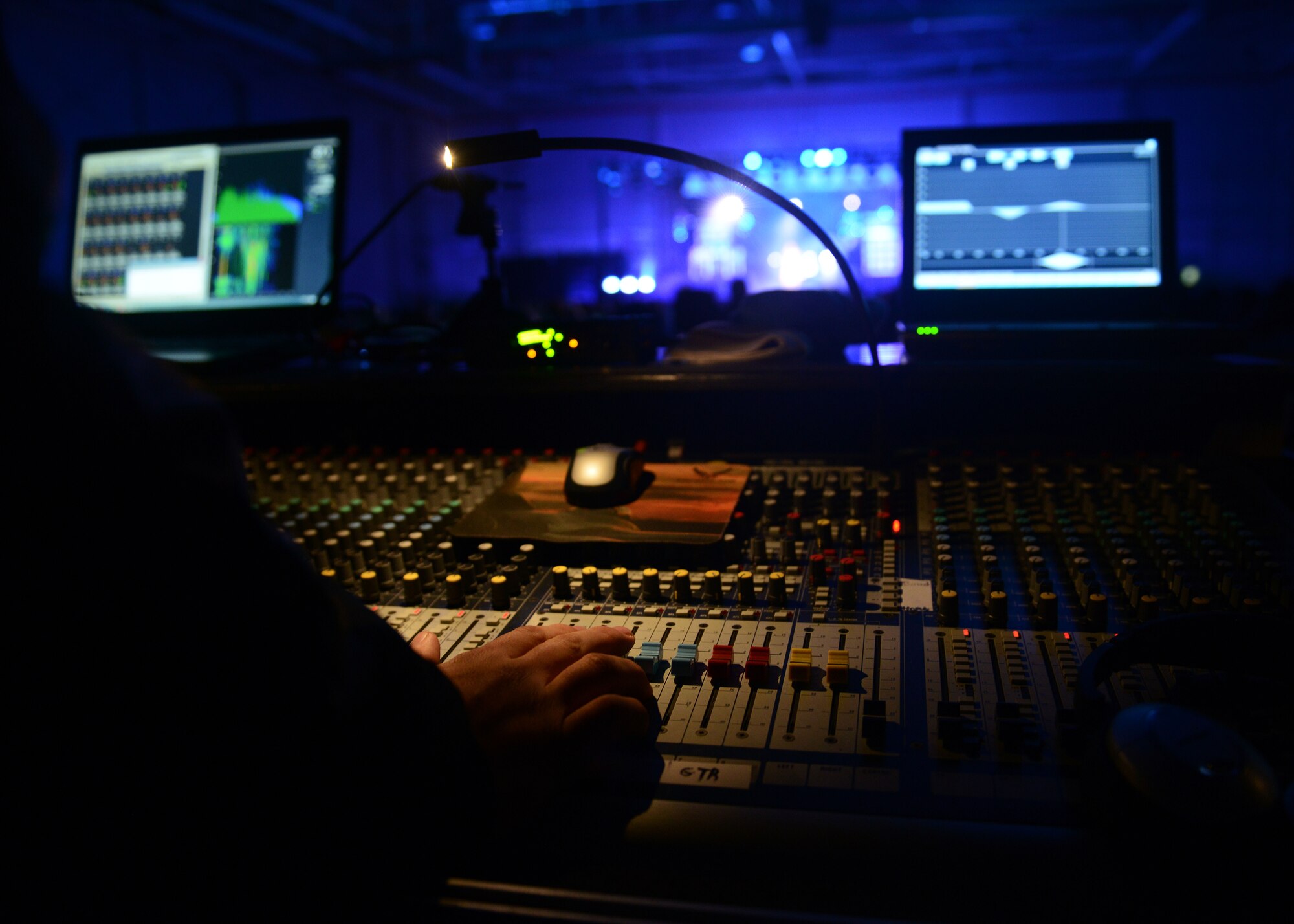 An audio engineer manages the sound board during a Tops in Blue performance, Dec. 9, 2014, at Aviano Air Base, Italy. Annually TIB looks for female and male vocalist, instrumentalists, dancers and non-musical performers to tour and entertain military installations. (U.S. Air Force photo/Airman 1st Class Deana Heitzman)