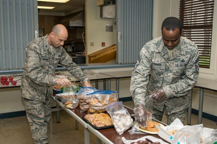 Col. Michael Gimbrone, 502nd Security Forces and Logistics Support Group commander, and Chief Master Sgt. Troy G. Palmer, Jr., 12th Flying Training Wing command chief, assemble bags of cookies as part of Operation Cookie Drop Dec. 10 at Joint Base San Antonio-Randolph’s Chapel One Kitchen Annex. The event was a combined effort from the local community and base population to bring homemade cookies to Airmen and provide a taste of home during the holiday season to all the single Airmen assigned to JBSA-Randolph. (U.S. Air Force photo by Johnny Saldivar)
