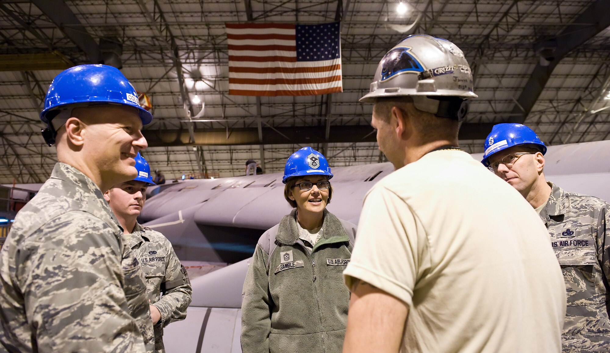 Chief Master Sgt. Victoria Gamble, Air Mobility Command chief, center, talks with Master Sgt. Jason Smith, 512th Maintenance Squadron crew chief, in the isochronal inspection dock Dec. 4, 2014, at Dover Air Force Base, Del. Gamble talked with aircraft maintainers as they worked on this C-5A Galaxy during day 39 of a scheduled 50-day inspection process. (U.S. Air Force photo/Roland Balik)