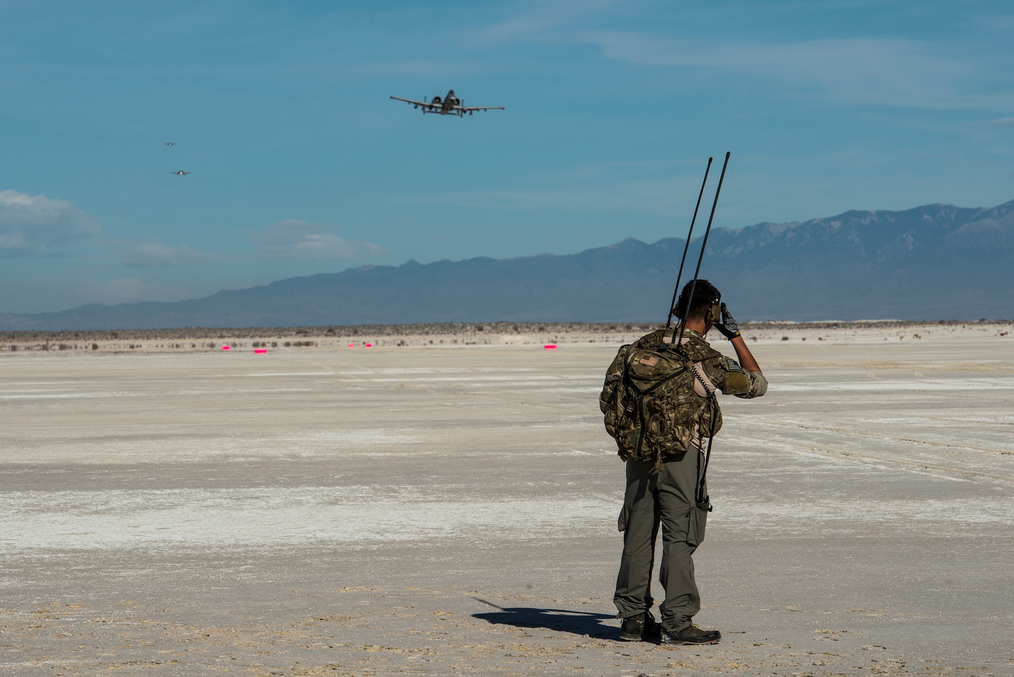 A combat controller from the 23d Special Tactics Squadron at Hurlburt Field, Fla., communicates with A-10C Thunderbolt II pilots, Dec. 3, 2014, at the White Sands Missile Range, N.M. Combat controllers secure and prepare runways in forward locations to support aircraft in austere environments. (U.S. Air Force Photo by Airman 1st Class Ryan Callaghan/Released)
