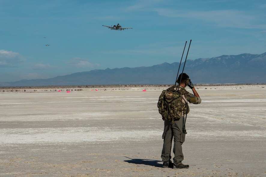A combat controller from the 23d Special Tactics Squadron at Hurlburt Field, Fla., communicates with A-10C Thunderbolt II pilots, Dec. 3, 2014, at the White Sands Missile Range, N.M. Combat controllers secure and prepare runways in forward locations to support aircraft in austere environments. (U.S. Air Force Photo by Airman 1st Class Ryan Callaghan/Released)