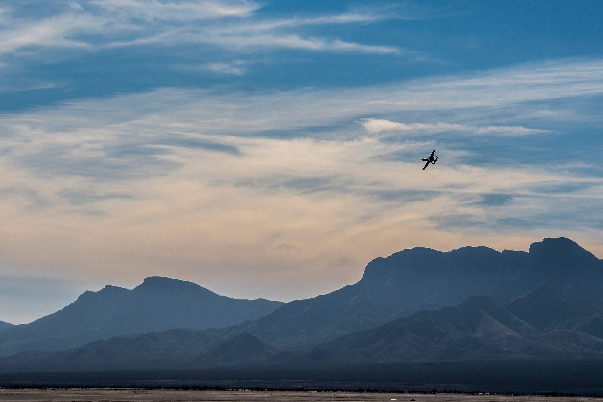 U.S. Air Force Maj. Dan Edgar, 74th Fighter Squadron assistant director of operations, banks an A-10C Thunderbolt II above mountainous terrain, Dec. 3, 2014, over White Sands Missile Range, N.M. White Sands Missile Range spans nearly 3,200 square miles and supports a variety of aircraft and live-fire operations. (U.S. Air Force Photo by Airman 1st Class Ryan Callaghan/Released)