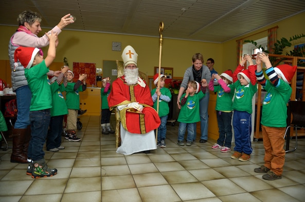 Children from St. Martin School in Bitburg, Germany, perform a skit for Sankt Nikolaus and visitors from Spangdahlem Air Base, Germany, Dec. 8, 2014. Nikolaus visited the school to meet with children and tell them Christmas stories. (U.S. Air Force photo by Airman 1st Class Kyle Gese/Released)