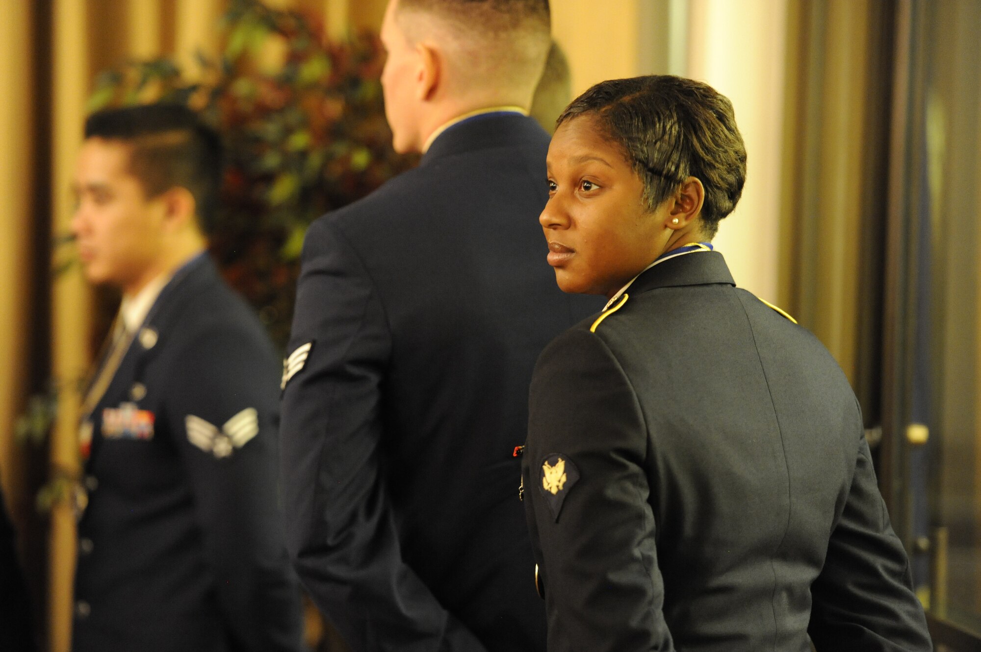 Spc. Jasmine Dandridge, 77th Sustainment Brigade material manager and Athens, Ga., native, waits amongst Airmen to receive her graduation certificate at the Kish Airman Leadership School graduation Dec. 4, 2014, at Joint Base McGuire-Dix-Lakehurst, N.J. Dandridge is the first Soldier to graduate the six-and-a-half week Kish ALS course. (U.S. Air Force photo by Airman 1st Class Sean M. Crowe/Released)