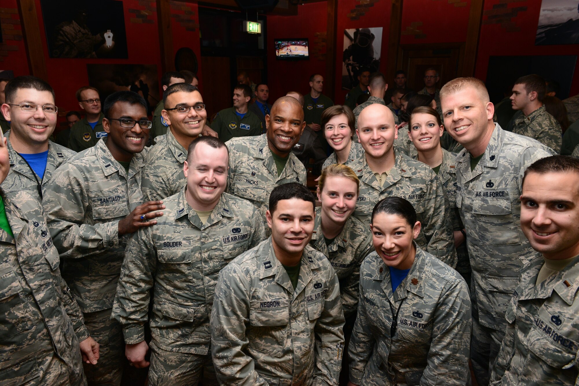 Ramstein Airmen pose for a photo during the reopening of the newly renovated Wings Lounge in the Officers’ Club at Ramstein Air Base, Germany, Dec. 5, 2014. The lounge was created for Airmen to be able to relax and have a good time with other Airmen and service members. (U.S. Air Force photo/Tech. Sgt. Travis Edwards)