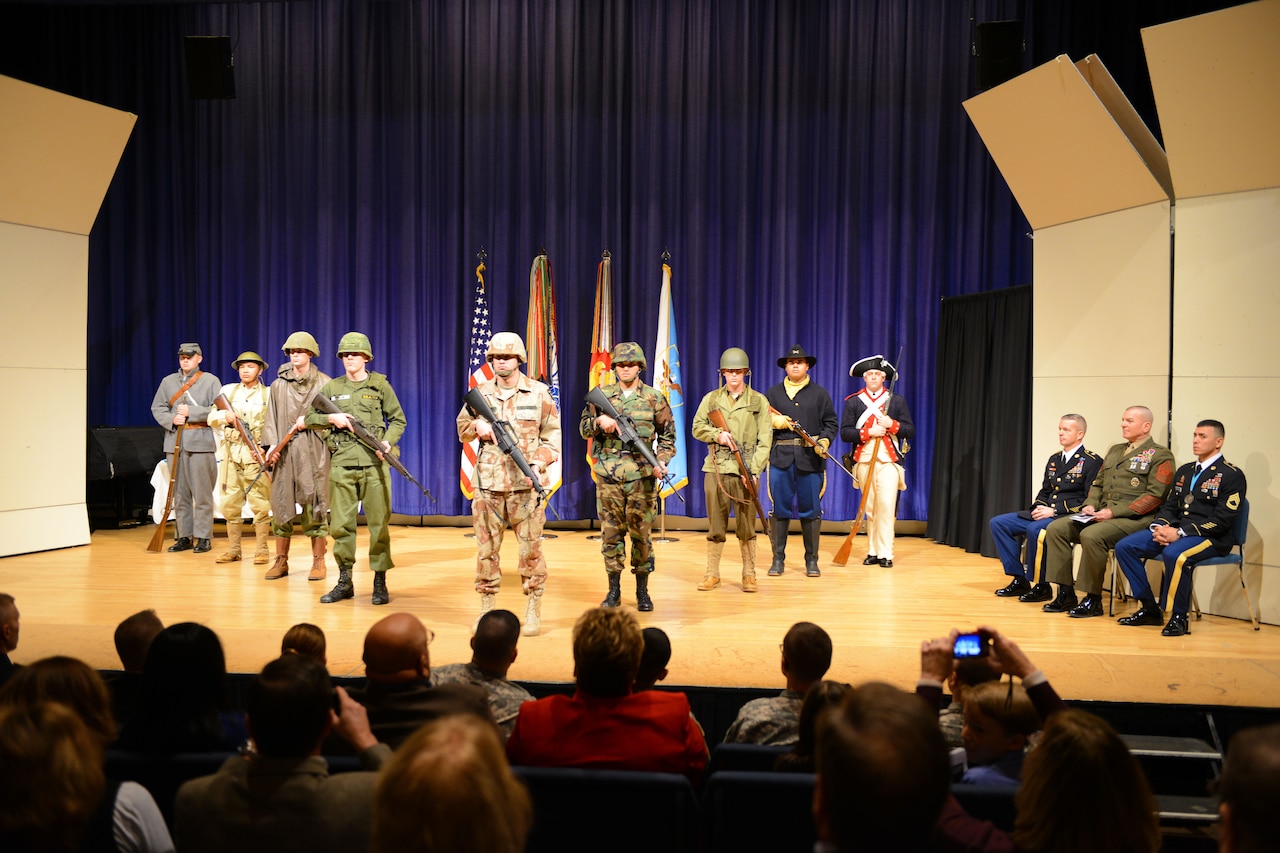 The Military District of Washington Sergeant Audie Murphy Club presents a history of the noncommissioned officer during an induction ceremony at Joint Base Myer-Henderson Hall, Va., Dec. 11, 2014. Six new members were inducted into the MDW chapter. DoD photo by Army Sgt. 1st Class Tyrone C. Marshall Jr.