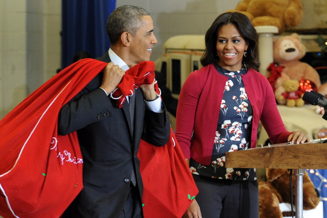 President Barack Obama and First Lady Michelle Obama bring bags of toys to support the U.S. Marine Corps Reserve Toys for Tots program on Joint Base Anacostia-Bolling in Washington, D.C., Dec. 10, 2014. 