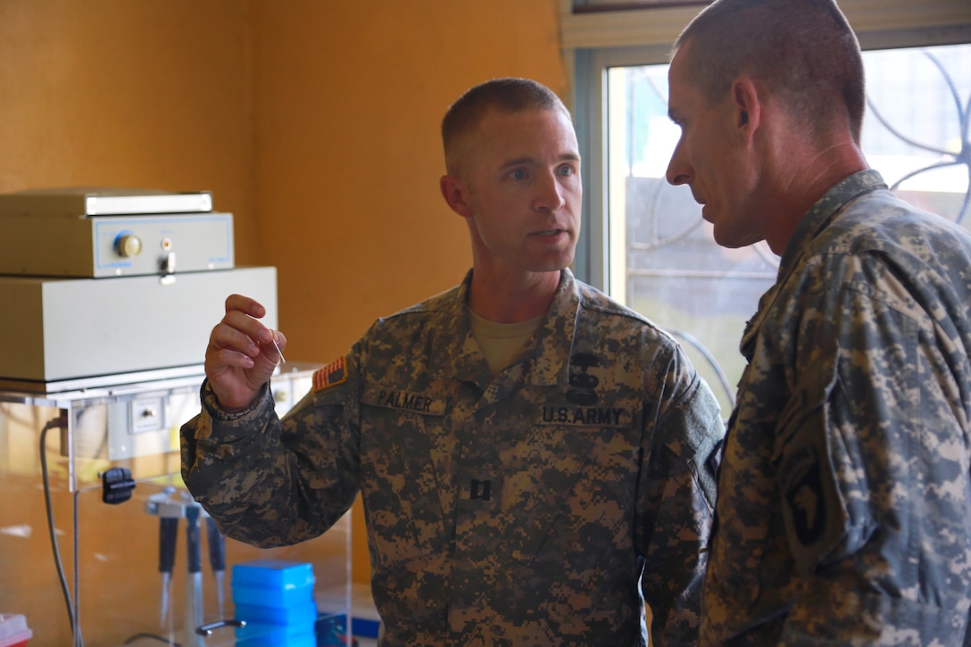 U.S. Army Capt. Sean Palmer, left, biochemist assigned to the 1st Army ...