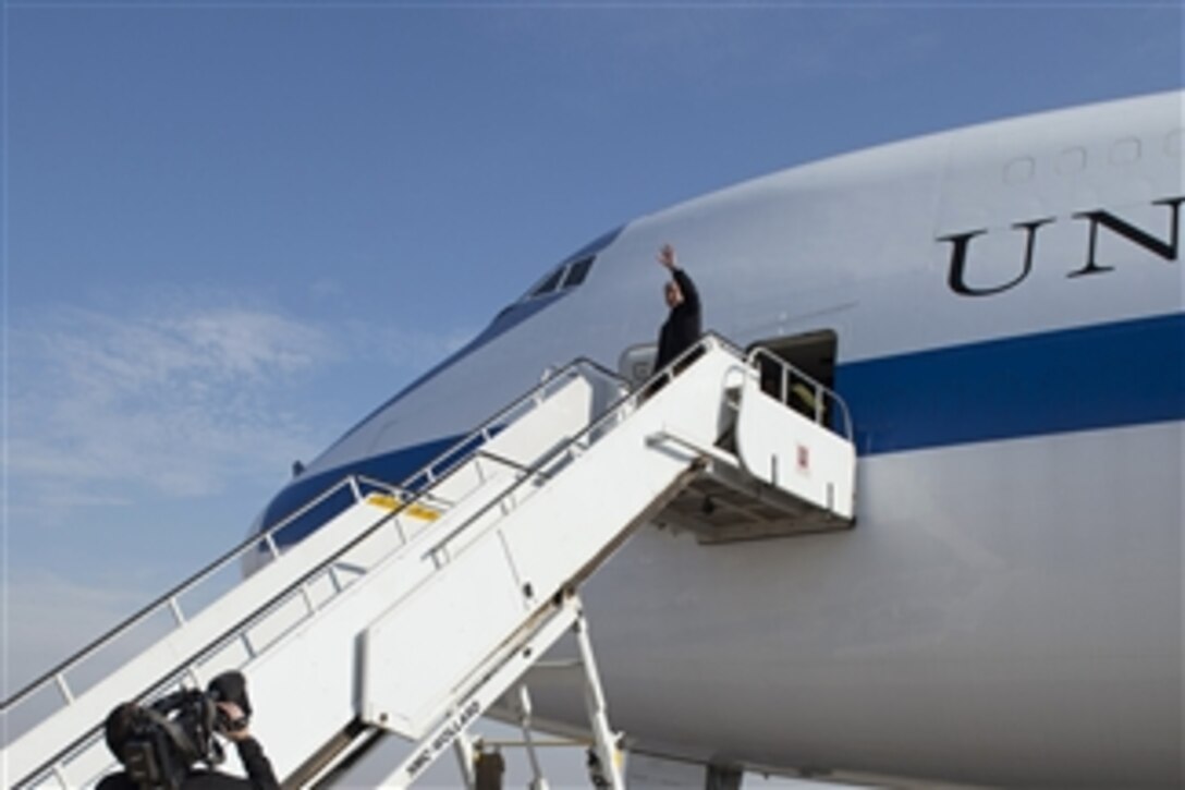 U.S. Defense Secretary Chuck Hagel waves goodbye as he prepares to depart the Kuwait International Airport in Kuwait City, Kuwait, Dec. 10, 2014, after a visit to the Middle East.