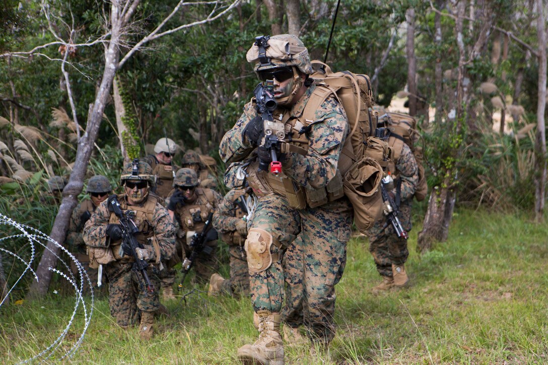 U.S Marine with Company E, Battalion Landing Team 2nd Battalion, 4th Marines, (BLT) 31st Marine Expeditionary Unit, moves towards targets while conducting a vertical assault at Combat Town, Okinawa, Japan, Dec. 8 Company E. is conducting training as part of the MEU Exercise and pre-deployment training. 