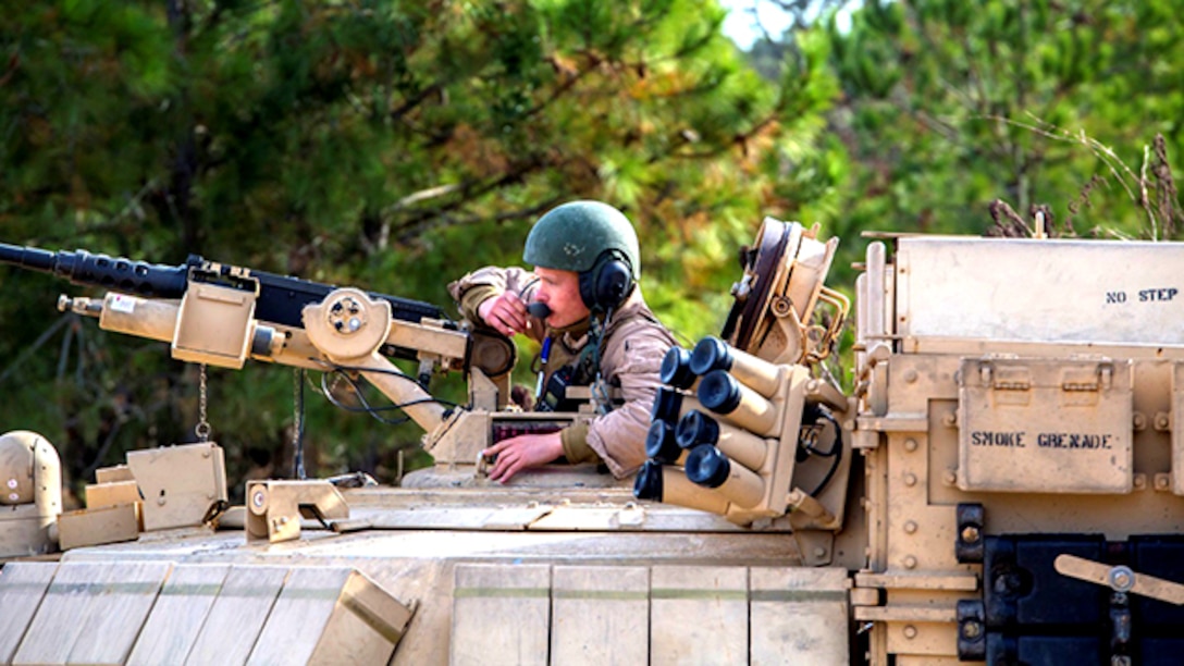 A Marine with 2nd Combat Engineer Battalion, 2nd Marine Division receives orders over the radio before conducting breaching exercises aboard Marine Corps Base Camp Lejeune, North Carolina, Dec. 8. Marines with 2nd Tank Battalion along with 2nd CEB worked together to conduct breaching exercises in which they provided support fire while Assault Breacher Vehicles eliminated tank pits and created a lane in which tanks may safely travel, aboard Camp Lejeune, Dec. 8-10.