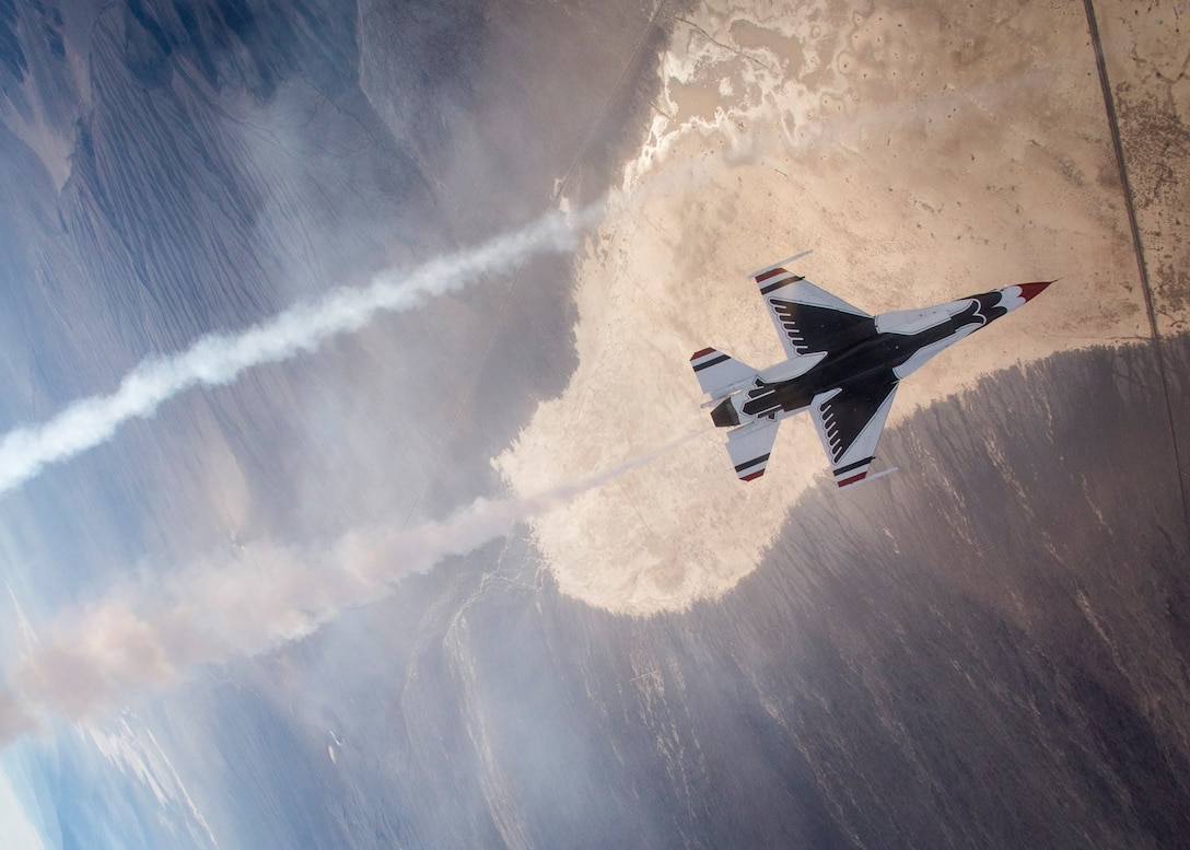 Maj. Blaine Jones demonstrates various Thunderbirds' maneuvers during a training sortie Dec. 10, 2014. The Thunderbirds conduct daily training flights to prepare for the upcoming 2015 show season. (U.S. Air Force Photo/Senior Airman Jason Couillard)