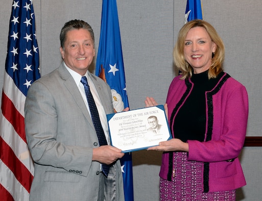 Secretary of the Air Force Deborah Lee James presents the 2014 Harold Brown Award to Dr. Don Erbschloe, Air Mobility Command’s chief scientist, Dec. 9, 2014, during a ceremony held in the Pentagon, Washington, D.C. The award is given by the Air Force to a scientist or engineer who applies scientific research to solve a problem critical to the needs of the Air Force. (U.S. Air Force photo/Andy Morataya)