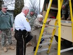Harwood Evacuation 478: Cass County Sherriff's Department Chief Deputy Jim Thoreson helps Mili Sherman up a ladder and into a North Dakota National Guard quick response force (QRF) truck in rural Cass County March 22, 2010. Thorson and the QRF team helped Sherman to temporarily vacate her home, because the rising over-land flood water covered her access road has made it dangerous to drive in and out of her roadway.