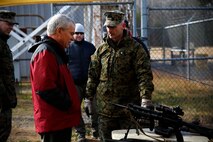 Lt. Col. Ethan Smith, product manager for Infantry Weapons at Marine Corps Systems Command, points out the M27 Infantry Automatic Rifle to Thomas Dee, deputy assistant secretary of the Navy for Expeditionary Programs and Logistics Management. Dee received briefings on several pieces of gear and equipment fielded by MCSC's Infantry Weapons Systems during a visit to the command Dec. 10.