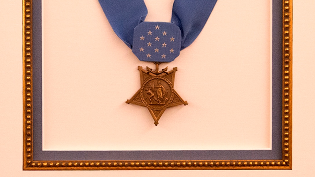 Lt. Vincent Capodanno's Medal of Honor hangs on the wall of the Capodanno Chapel aboard The Basic School, Marine Corps Base Quantico, Virginia, Dec. 9, 2014. Chaplain Capodanno served with 3rd Battalion, 5th Marine Regiment during the Vietnam War and was posthumously awarded the Medal of Honor for his actions. His Medal of Honor and original citation now have a special place in the Capodanno Chapel. (U.S. Marine Corps photo by Sgt. Melissa Karnath/Released)