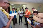 U.S. Air Force Staff Sgt. Harry Mitchell (left), a medical technician with 140th Wing Medical Group of the Colorado Air National Guard, reads a data sheet to the group about the Hawaiian population during a cultural familiarization briefing at the Kahuku Medical Center in Kahuku, Hawaii, March 14, 2010. Mitchell and more than 60 of his fellow Colorado Air Guardsman are on the island of Oahu providing services to the medically under-served within the state of Hawaii