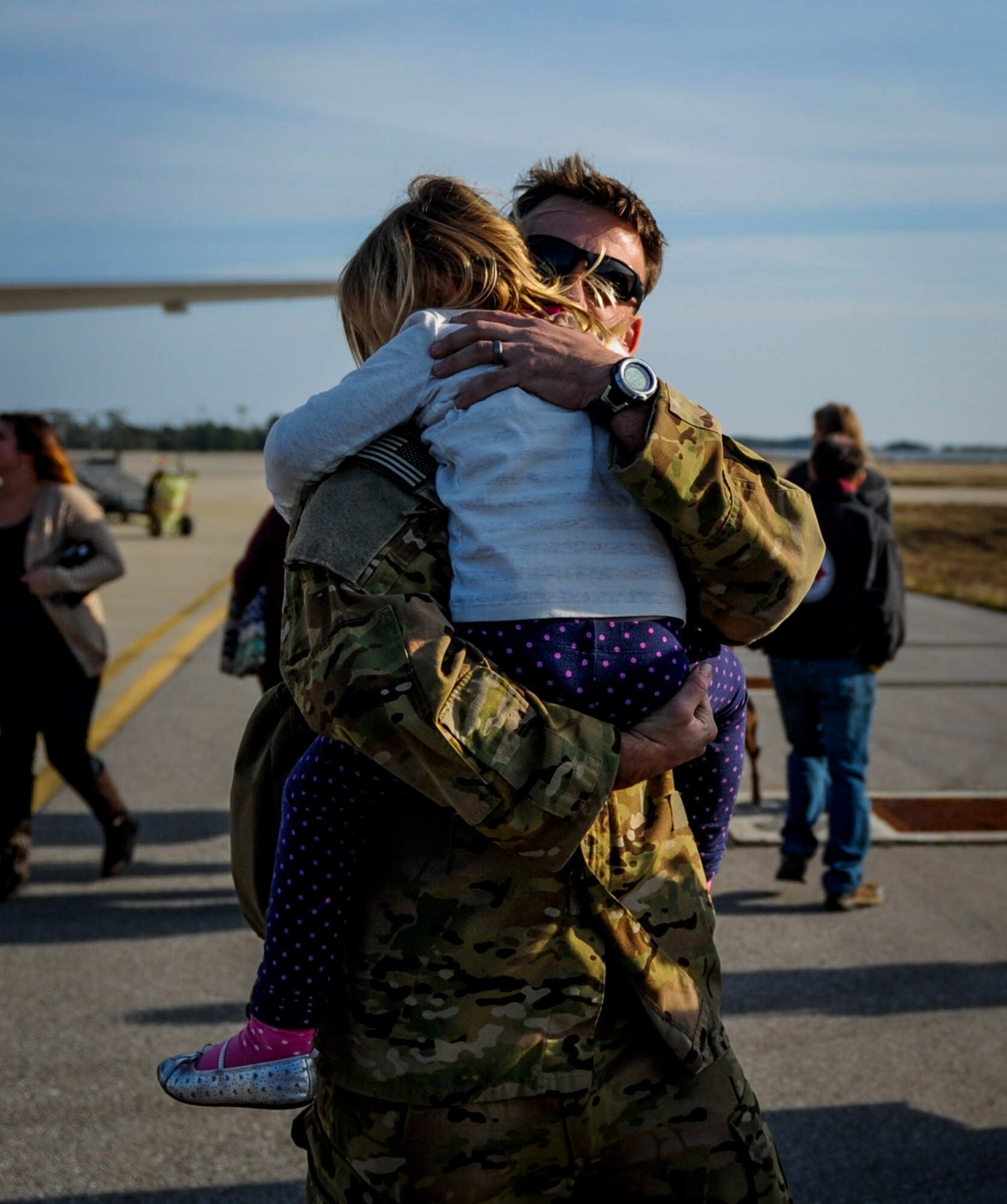Tech. Sgt. Jeff Hieber, 4th Special Operations Squadron sensor operator embraces his daughter, Elliot, during Operation Homecoming Dec. 11, 2014, after returning to Hurlburt Field, Fla. from a deployment. Operation Homecoming welcomed home more than 40 Air Commandos. (U.S. Air Force photo/Senior Airman Christopher Callaway)