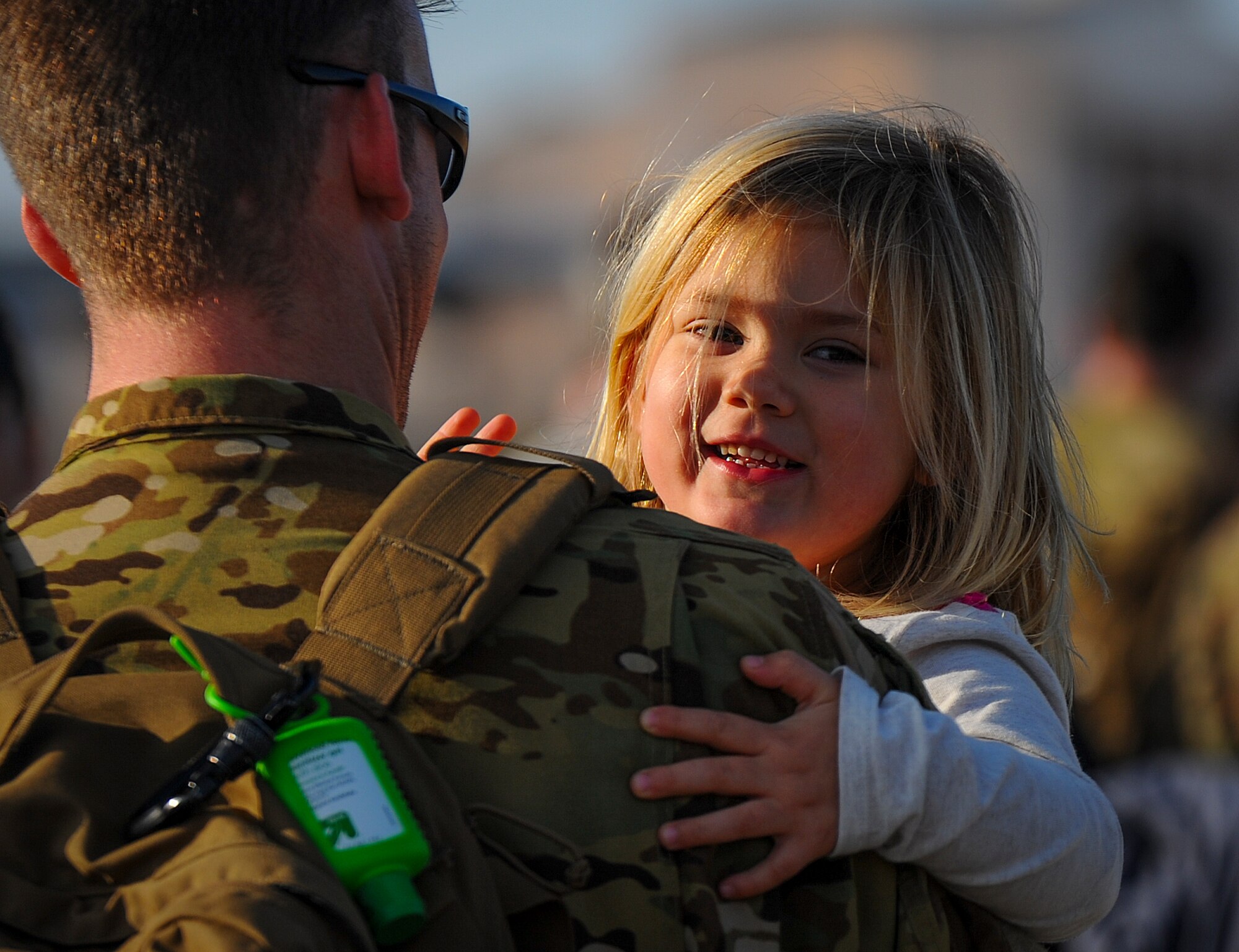 Tech. Sgt. Jeff Hieber, 4thSpecial Operations Squadron sensor operator embraces his daughter, Elliot, during Operation Homecoming Dec. 11, 2014, after returning to Hurlburt Field, Fla. from a deployment. Operation Homecoming welcomed home more than 40 Air Commandos. (U.S. Air Force photo/Senior Airman Christopher Callaway)