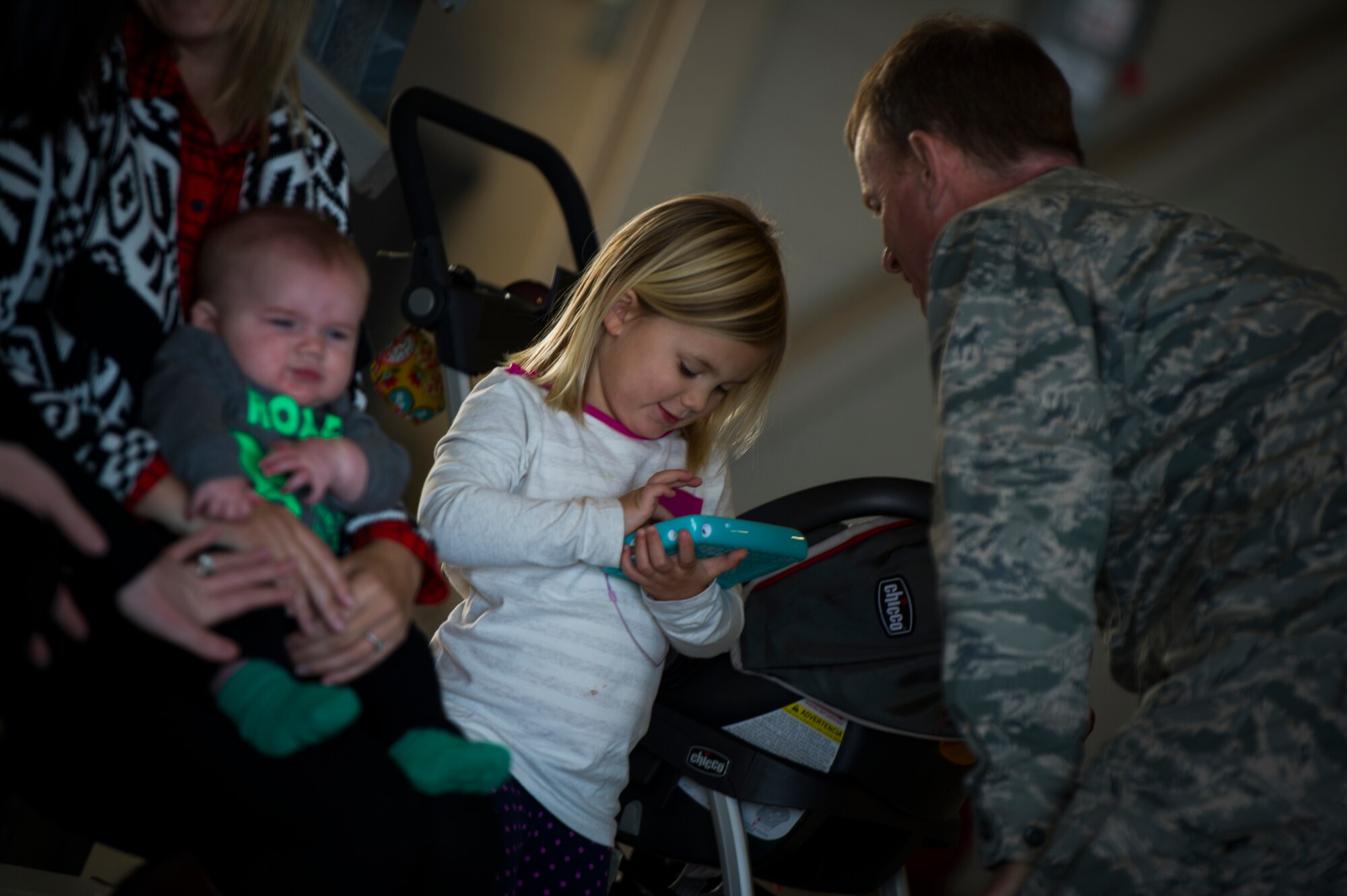 Col. Bill West, 1st Special Operations Wing commander, speaks with Elliot Heiber, daughter of Tech Sgt. Jeff Heiber, 4th Special Operations Squadron sensor operator, on Hurlburt Field, Fla., Dec. 11, 2014. Elliot was waiting for her father to return home from a deployment. (U.S. Air Force photo/Senior Airman Christopher Callaway) 
