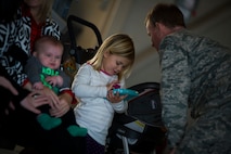 Col. Bill West, 1st Special Operations Wing commander, speaks with Elliot Heiber, daughter of Tech Sgt. Jeff Heiber, 4th Special Operations Squadron sensor operator, on Hurlburt Field, Fla., Dec. 11, 2014. Elliot was waiting for her father to return home from a deployment. (U.S. Air Force photo/Senior Airman Christopher Callaway) 