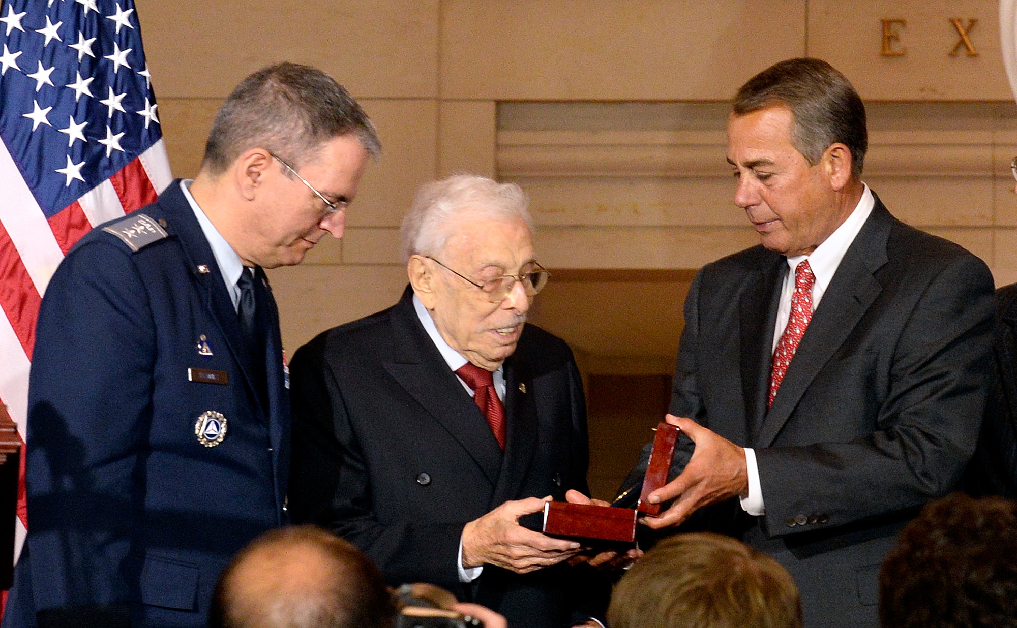Civil Air Patrol National Commander Joseph Vazquez looks on as Speaker of the U.S. House of Representatives John Boehner presents the Congressional Gold Medal to Lester Wolff, a former member of Congress and Civil Air Patrol veteran, during a ceremony Dec. 10, 2014, on Capitol Hill, Washington, D.C.  Vazquez and Wolff accepted the medal on behalf of the CAP World War II members.  (U.S. Air Force/Andy Morataya)