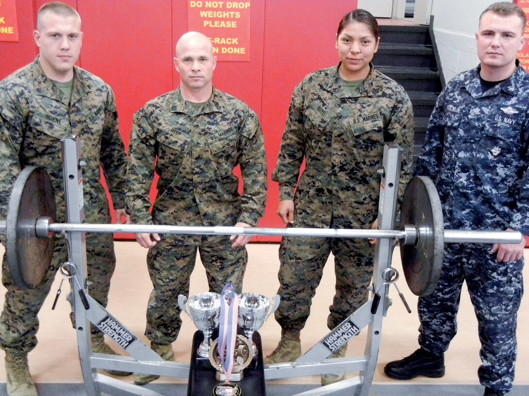 Members of Quantico Power Lifting Team are Cpl. Joshua Horne, left, combat instructor, The Basic School; Staff Sgt. Matthew Reep, platoon sergeant, Warfighting Company, Infantry Platoon, The Basic School; Private First Class Tiffany Boyd, data network specialist, Marine Corps Network Operations and Security Center; and Petty Officer Third Class Caleb Stricklin, corpsman, David R. Ray Branch Health Clinic.