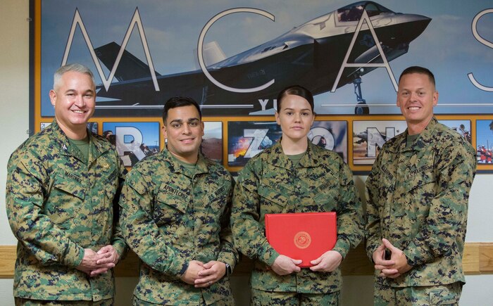 During the meritorious promotion of Sgt. Erika M. Cruz, the 2014 Marine Corps Installations West Marine of the Year, the Marine Corps Air Station Yuma, Ariz., commanding officer, Col. Ricardo Martinez, recognized all of Cruz’s accomplishments Monday, Nov. 3, 2014. From left to right, MCAS Yuma commanding officer, Col. Ricardo Martinez; Sgt. Kenneth AponteCruz, a food service technician with Headquarters and Headquarters Squadron; Sgt. Erika M. Cruz, the non-commissioned officer-in-charge at the military post office and the Marine Corps Installations West Marine of the Year; and Sgt. Maj. Colen B. Laarman, the sergeant major of MCAS Yuma.