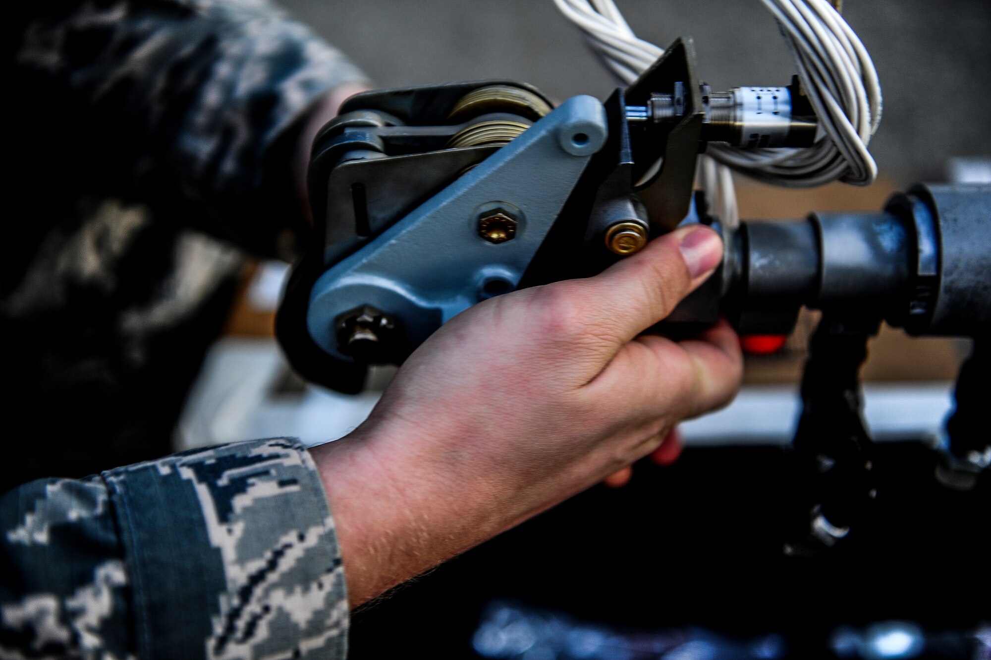 Staff Sgt. James Klutts, 9th Aircraft Maintenance Unit dedicated crew chief, handles equipment at Hurlburt Field, Fla., Dec. 8, 2014. The 15th AMU’s mission is to perform equipment maintenance in support of worldwide special operations missions. (U.S. Air Force photo/Senior Airman Christopher Callaway) 