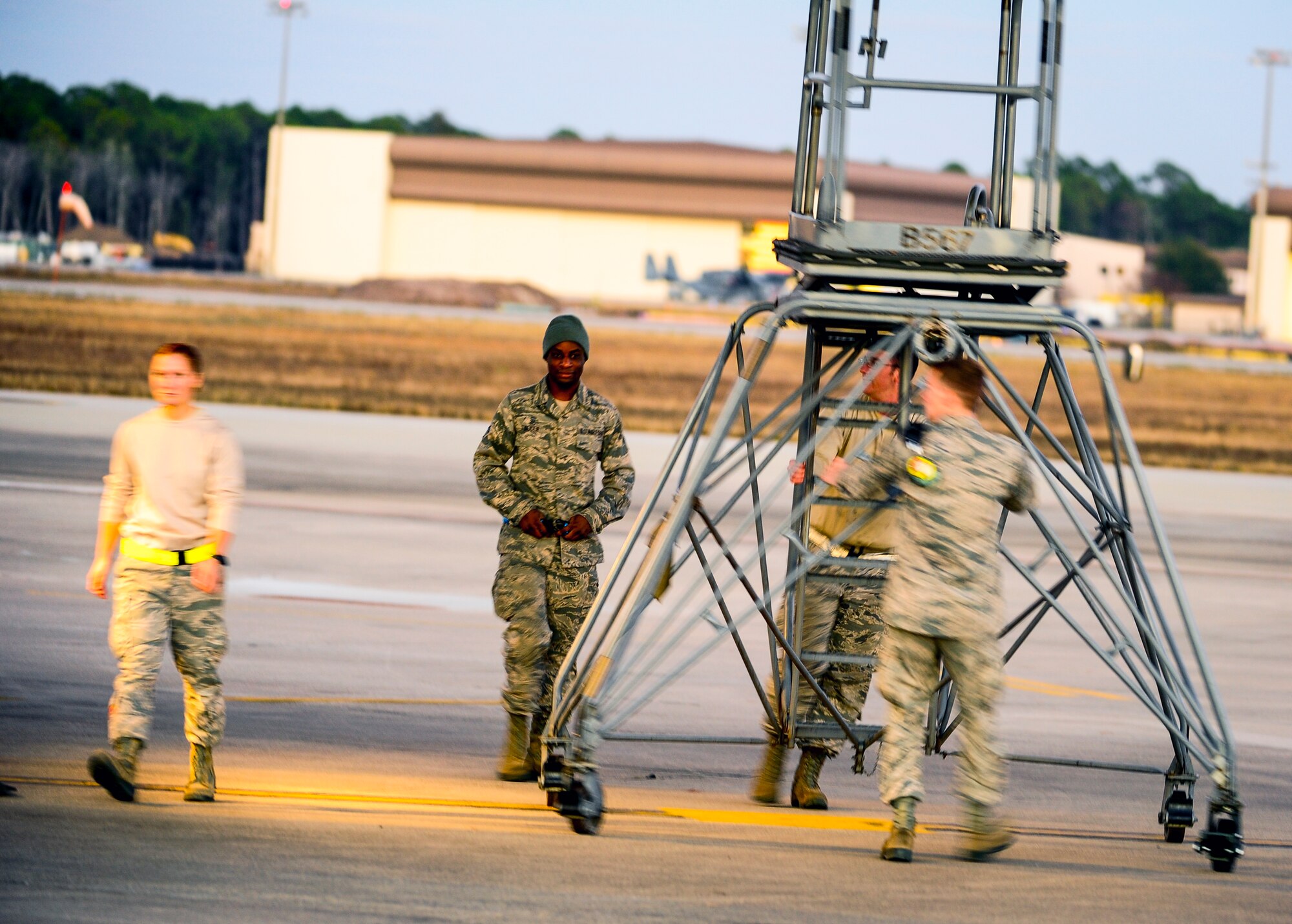 Airmen from the 1st Special Operations Maintenance Group push a maintenance stand at Hurlburt Field, Fla., Dec. 8, 2014. The 1st SOMXG provides support to more than 70 aircraft, assigned to the 1st Special Operations Wing. (U.S. Air Force photo/Senior Airman Christopher Callaway) 