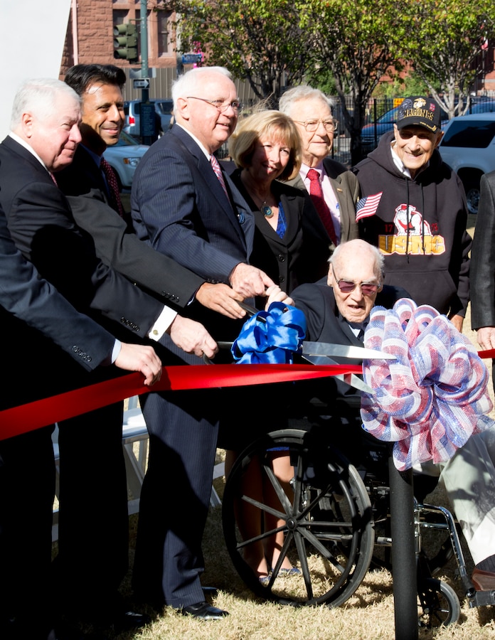 Board members of the National World War II Museum in New Orleans cut the ceremonial ribbon of the museum’s newest exhibit, “The Road to Berlin,” in the museum’s Campaigns of Courage Pavilion, Dec. 12, 2014. Many active duty military members, as well as World War II veterans, attended the ceremony. The exhibit will open to the public Dec. 13, 2014.