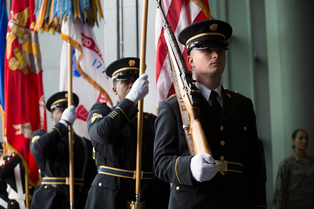 A joint service color guard marches in a ceremony at the National World War II Museum in New Orleans, Dec. 12, 2014.  The ceremony marked the museum’s newest exhibit, “The Road to Berlin,” which commemorates the path that led to D-Day and the fierce battles that followed. 